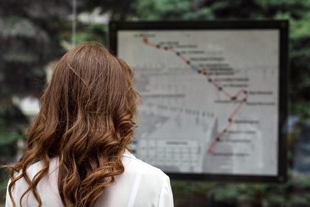 woman looks at map of public transport routeの写真素材