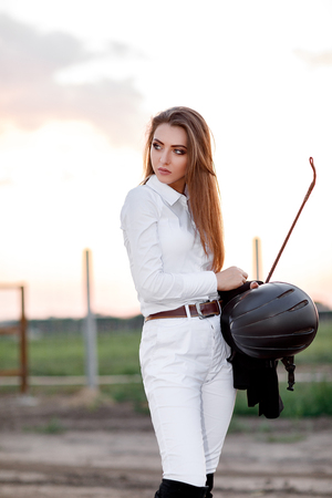 portrait of elegant rider woman with whipの写真素材