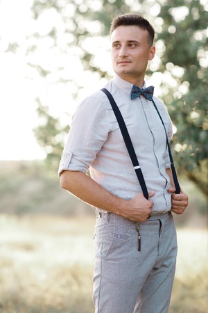Portrait of a young handsome groom outdoors.の写真素材