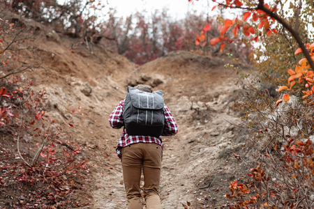 young man tourist with backpack walking on nature.の写真素材