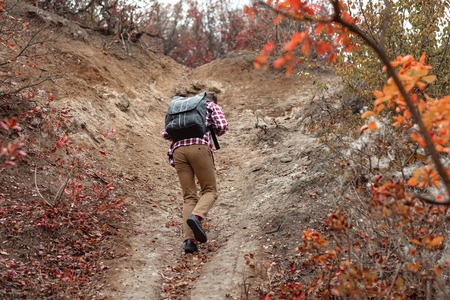 young man tourist with backpack walking on nature.