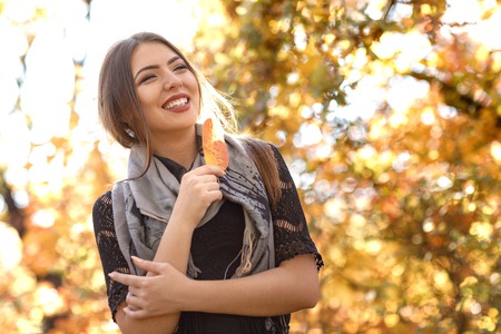 beautiful woman with gray scarft in autumnの写真素材