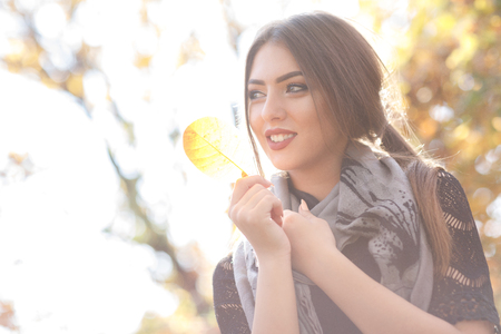 beautiful woman with gray scarft in autumnの写真素材