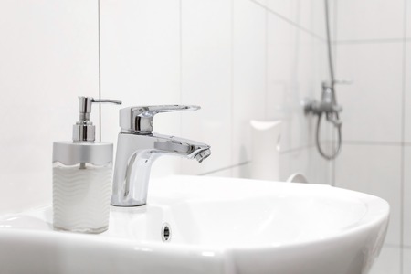 white sink with Steel faucet in a bathroom