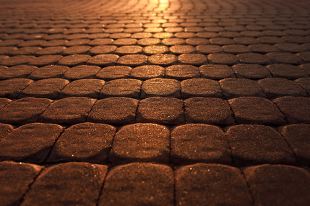 road from paving stones at the sunsetの写真素材