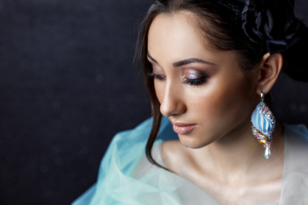 beautiful woman with beautiful hair, makeup and with luxury earringsの写真素材