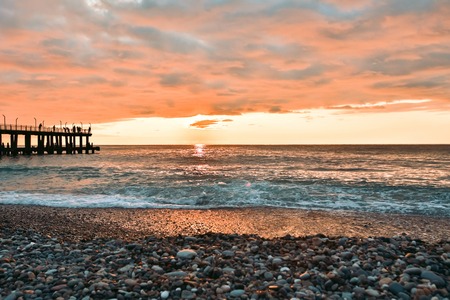 Stony beach after sunset. Beautiful beach full of pebbles in the coastline