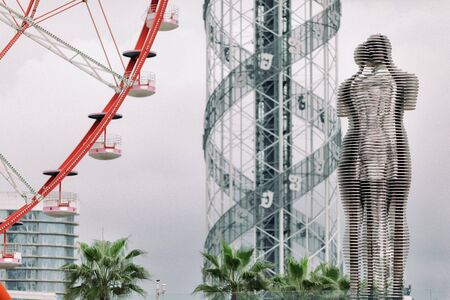 BATUMI, GEORGIA - September 10, 2018: Moving sculpture "Ali and Nino" , Alphabet tower and ferris wheel in Batumi, Georgiaのeditorial素材