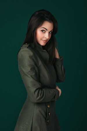 sexy young woman in lingerie and coat posing in the studio.の写真素材