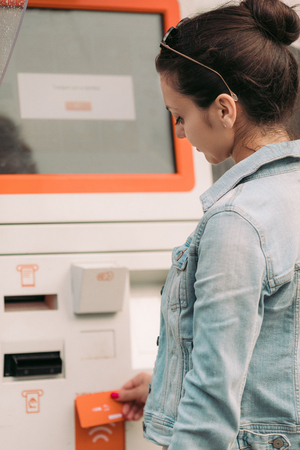 Tourist woman buys tickets for transport in Georgia. modern street machine for purchase of tickets for busの写真素材