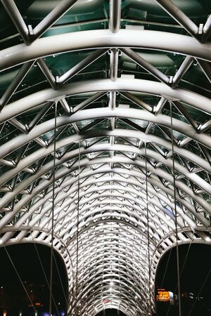 Tbilisi, Georgia - September 16, 2018: glass Peace Bridge at night in Tbilisi, Georgiaのeditorial素材