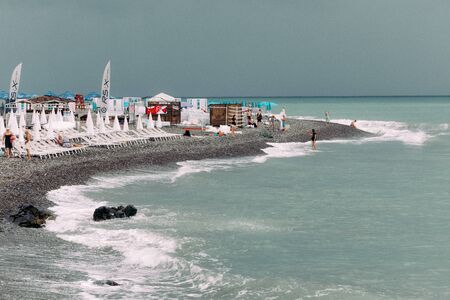 BATUMI, GEORGIA - September 10, 2018: Batumi city stone beach with tourists having rest in the daytimeのeditorial素材