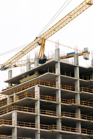 construction yellow crane against the sky. crane works at a construction site