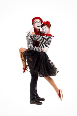 Smiling mimes in striped shirts. Man and woman dancing isolated on white backgroundの写真素材