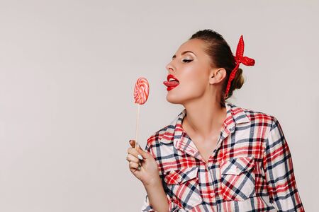 beautiful pin-up woman with lollipop. Copy space for textの写真素材