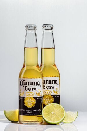 Dnipro, Ukraine - July 21, 2019: Corona bottle with lime fruit ready to drink on white background. Corona Extra is produced in Mexico and exported to all other countries all over the world.のeditorial素材