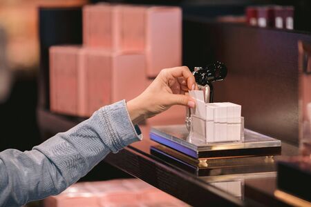 woman customer looking cosmetics in make-up shop