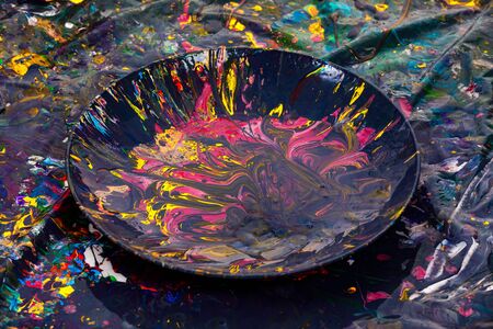 container with multi-colored paints. paint residues after paintingの写真素材