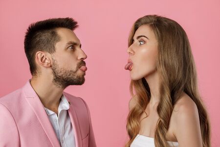 beautiful couple in love have fun on st valentines day. man and woman on pink backgroundの写真素材