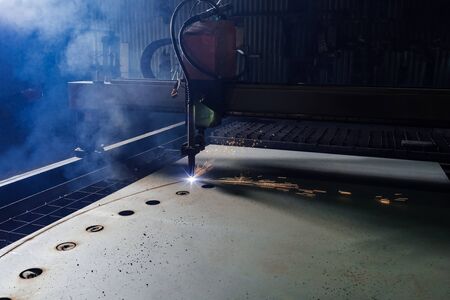 Plasma cutting of metal with a cnc. Plasma cutting machine cutting steel sheet. Laser cutter in production. Industrial metal cutting by plasma laserの写真素材