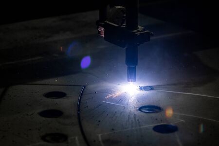 Plasma cutting of metal with a cnc. Plasma cutting machine cutting steel sheet. Laser cutter in...