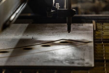 Plasma cutting of metal with a cnc. Plasma cutting machine cutting steel sheet. Laser cutter in production. Industrial metal cutting by plasma laserの写真素材