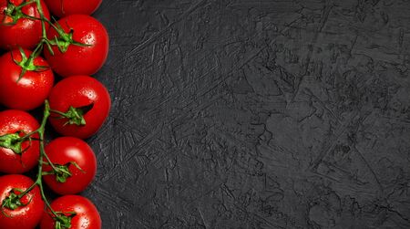 fresh red tomatoes on dark background. Top view. copy spaceの写真素材
