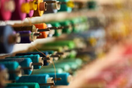 Colorful cotton thread rolls for sewing machine in store. thread spools for garment industryの写真素材