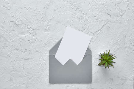 white blank card in gray envelope on cement texture background. mockup. Top view.の写真素材