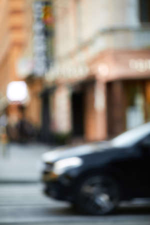 blurcar on crosswalk. cars driving on the road in the city