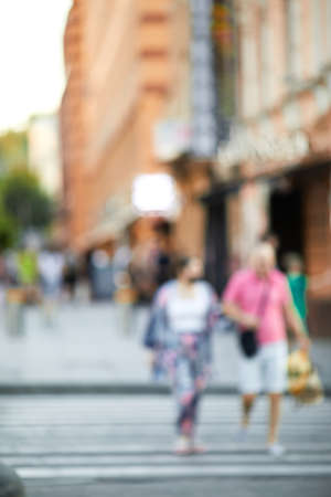 blurred people crossing street in the city. crosswalkの写真素材