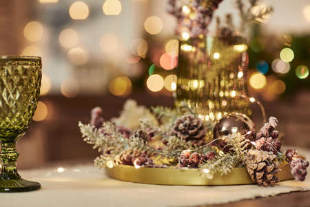 two green glasses on a wooden table. Christmas decorations