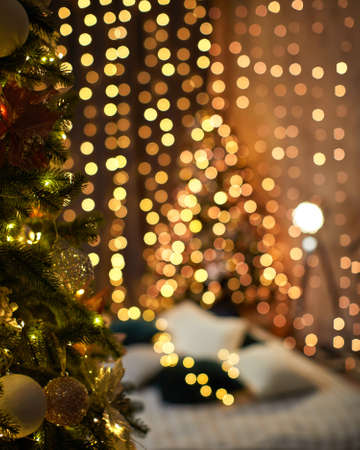 Christmas tree on blur background of christmas decorated interior. copy space for textの写真素材
