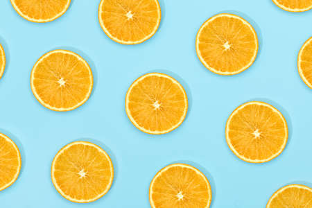 fruit pattern of fresh ripe slice orange on blue background. top view