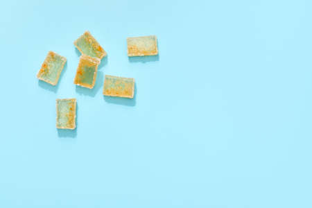 orange jelly slices in sugar on blue background. citrus marmalade. top viewの写真素材