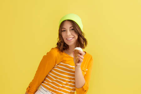 woman in hat with vanilla ice creamの写真素材