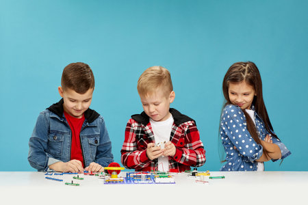 children playing with electronic constructor at studio