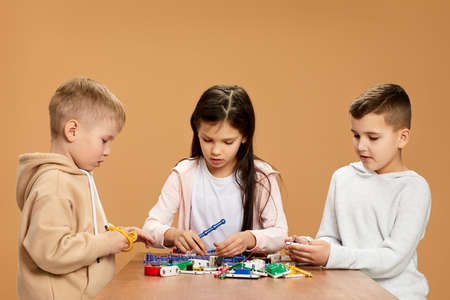 enthusiastic children collect electronic circuits at studioの写真素材