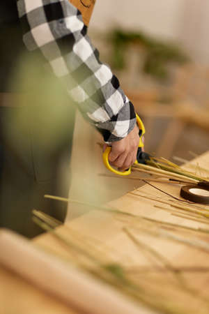 florist makes beautiful bouquet of dried flowersの写真素材