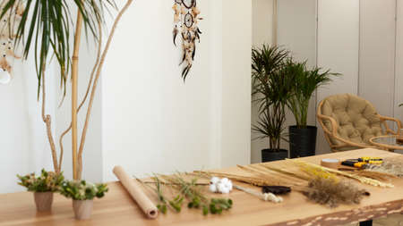 dried flowers and herbs on a table in a florist workshopの写真素材
