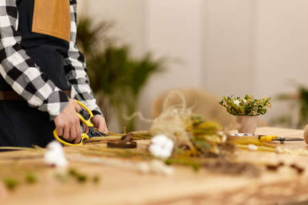 florist makes beautiful bouquet of dried flowersの写真素材