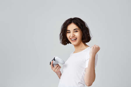 girl playing video games on gray backgroundの写真素材