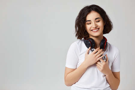 girl playing video games on gray backgroundの写真素材