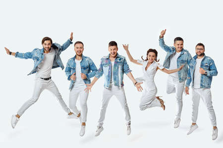 crazy men and woman in denim t-shirt jeans jumping high