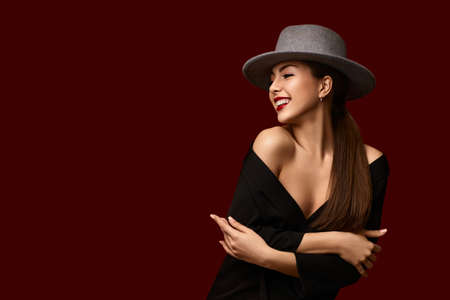 portrait of fashionable beautiful girl on red bakground.の写真素材