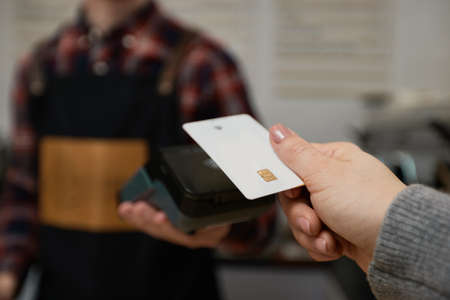 customer hand holding credit card near nfc terminal.の写真素材
