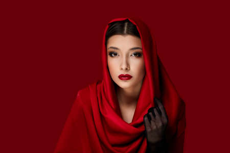 brunette woman with red lips and veil over her headの写真素材