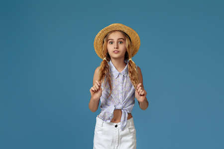 funny little girl in summer hat and sunglasses