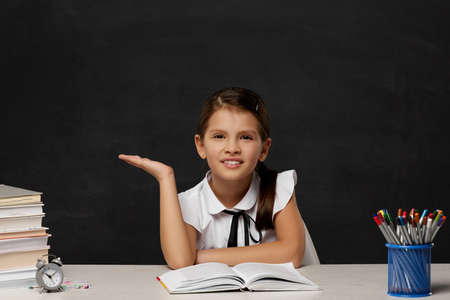 puzzled little child girl in the classroomの写真素材