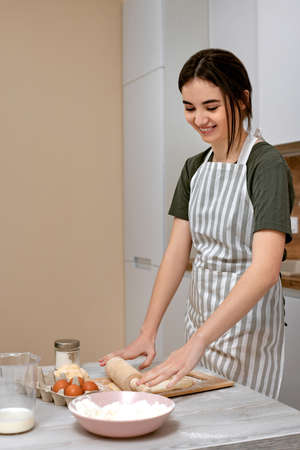 Young beautiful housewife cooking on kitchen at home.の写真素材